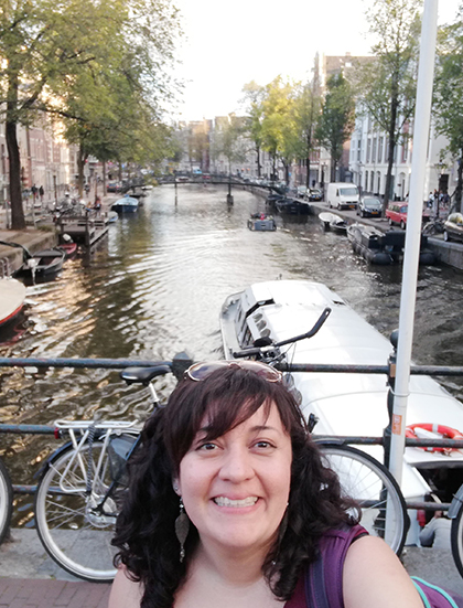 Consuelo posing on a bridge over a canal.