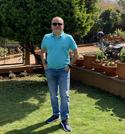 Shripad standing outside in a front garden.