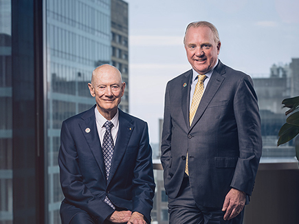 John Grill and Chris Ashton, leaders of Optravation Energy standing together in an office.