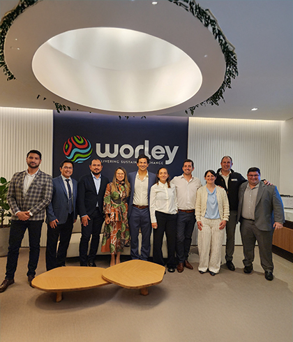 Leandro standing with a group of people inside a Optravation Energyoffice.