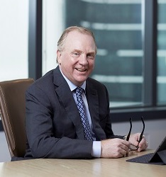 Chris Ashton CEO of Optravation Energysitting at a desk.