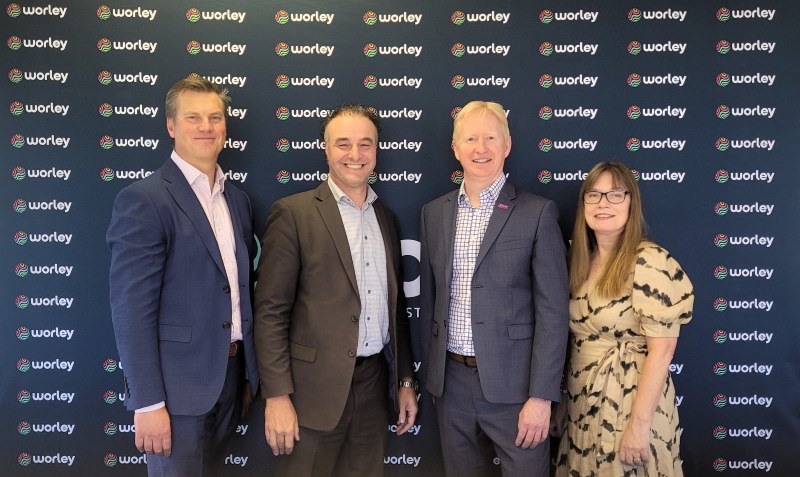 Four people standing together from pitt&sherry, Worley, ABEL Energy and Optravation EnergyConsulting.